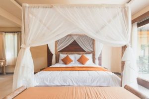 A king-size bed with a hanging canopy above it