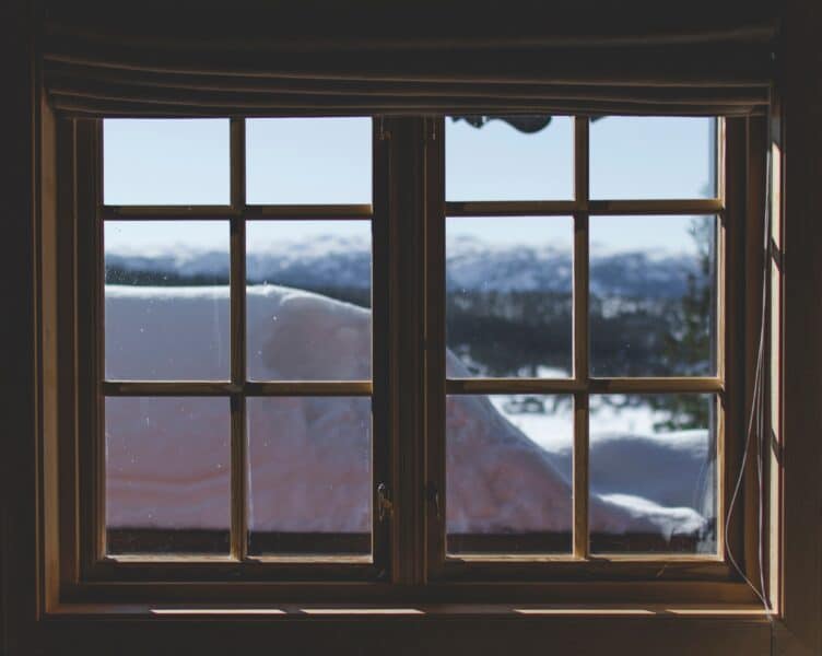 An image of an old window showing snow outside